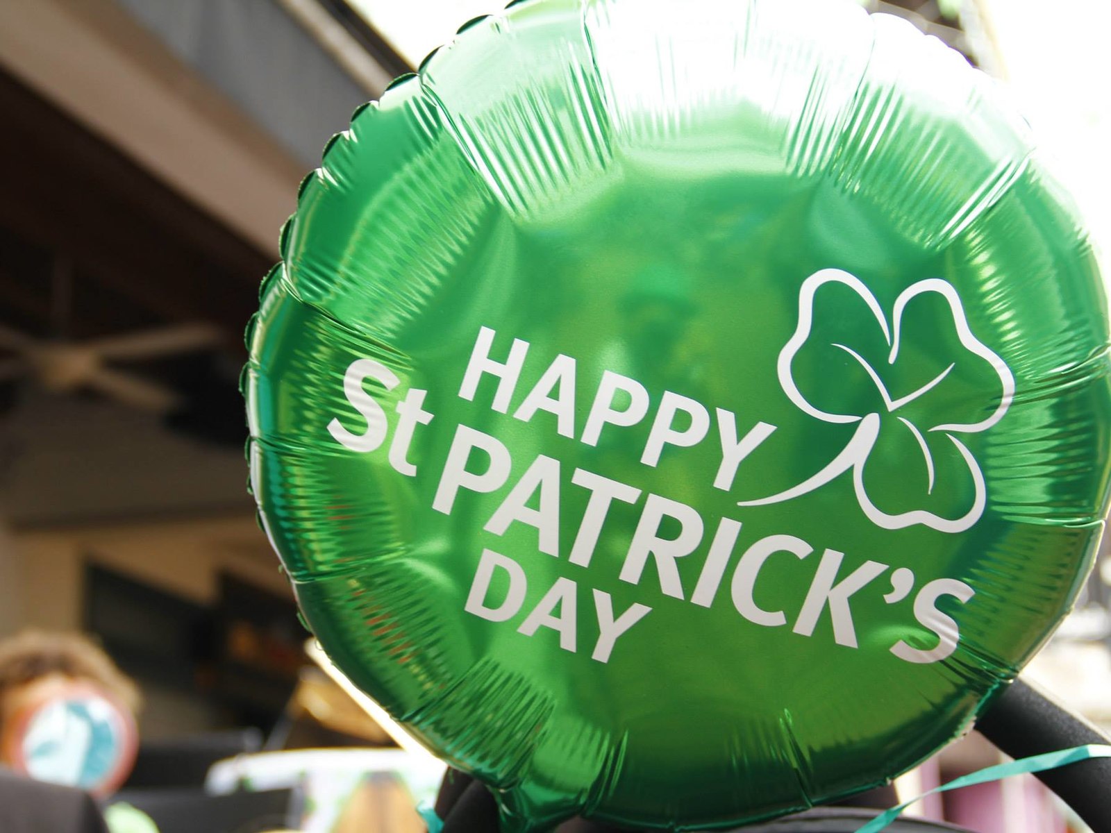 A festive St. Patrick's Day celebration with people dressed in green, featuring traditional Irish decorations and food.